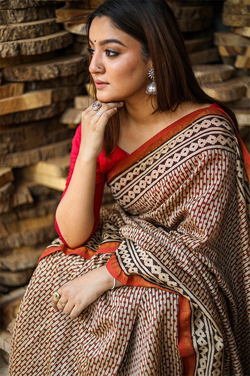 women sitting wearing a chanderi silk saree