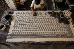 Fabric laid out on a traditional printing table before Bagru hand block printing