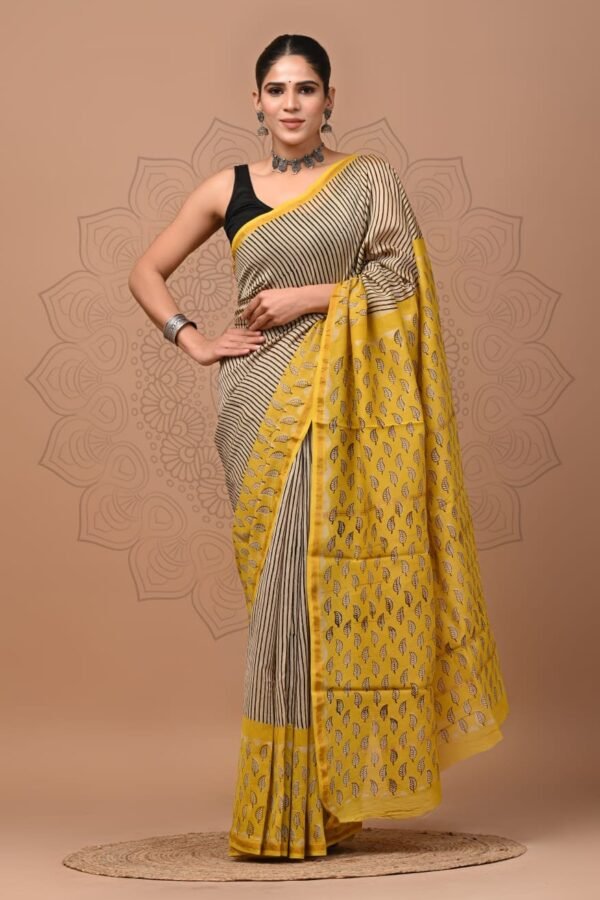 Woman wearing beige striped Chanderi silk saree with yellow Bagru hand block printed leaf border