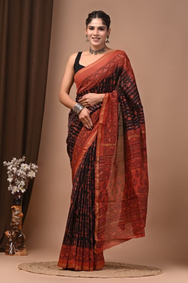 Woman wearing black and rust Chanderi silk saree with Bagru hand block printed paisley motifs