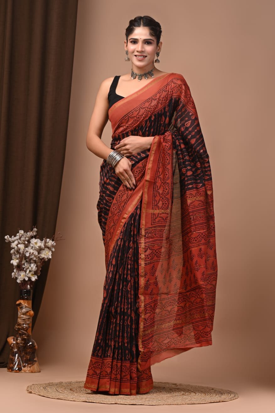Woman wearing black and rust Chanderi silk saree with Bagru hand block printed paisley motifs