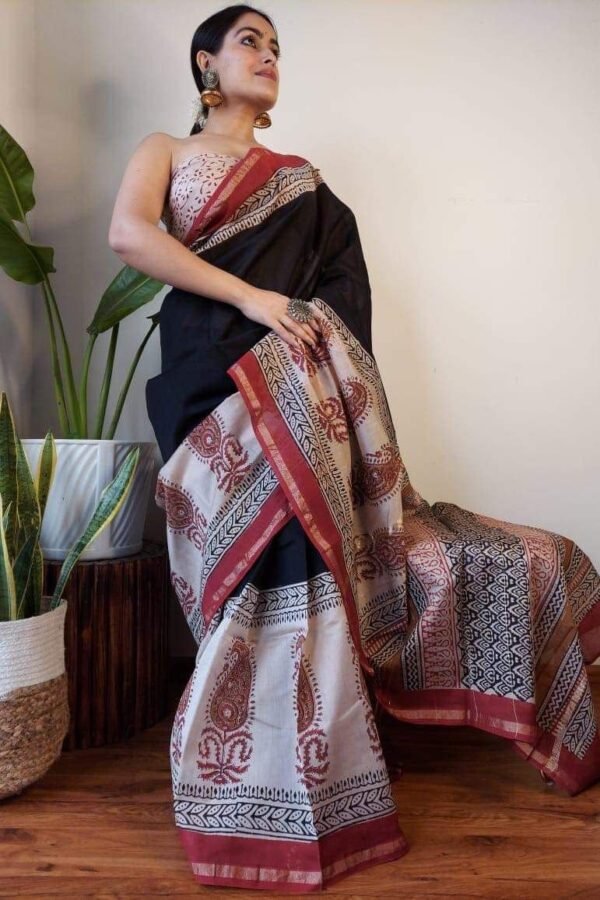 Woman in black Chanderi silk saree with cream Bagru paisley print border and pallu