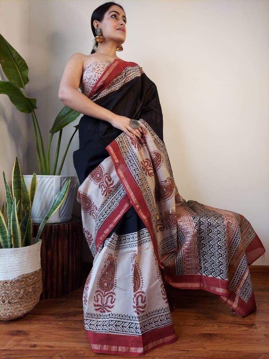 Woman in black Chanderi silk saree with cream Bagru paisley print border and pallu