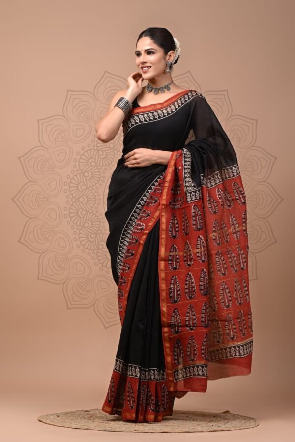 Woman wearing black Chanderi silk saree with rust-red Bagru hand block leaf print pallu and border