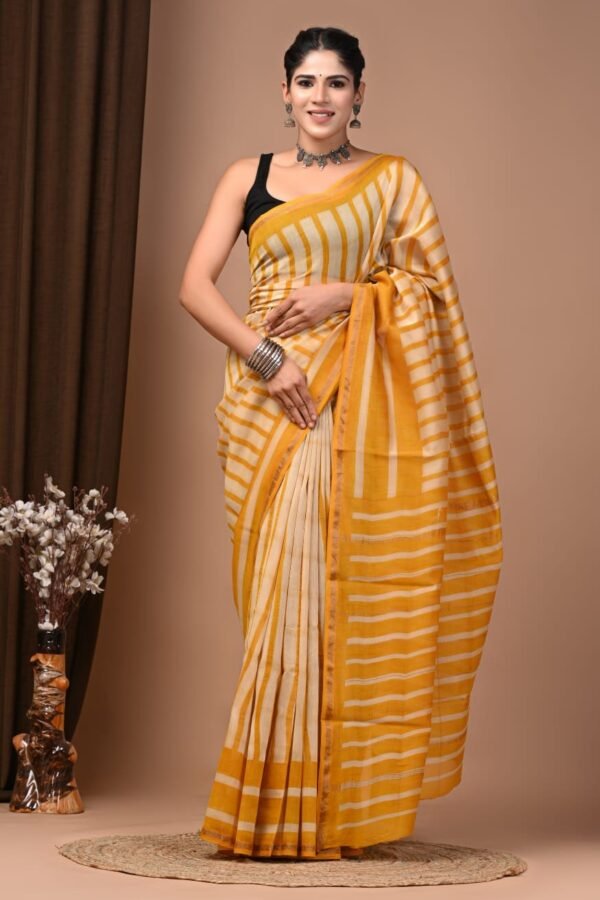 Woman wearing mustard yellow and cream striped hand block printed Chanderi silk saree