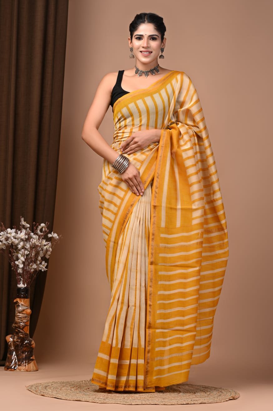 Woman wearing mustard yellow and cream striped hand block printed Chanderi silk saree