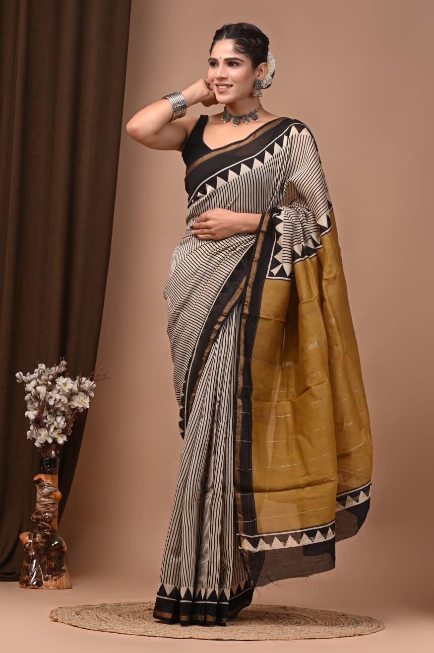 Cream and mustard Chanderi silk saree with Bagru hand block chevron border, draped on model