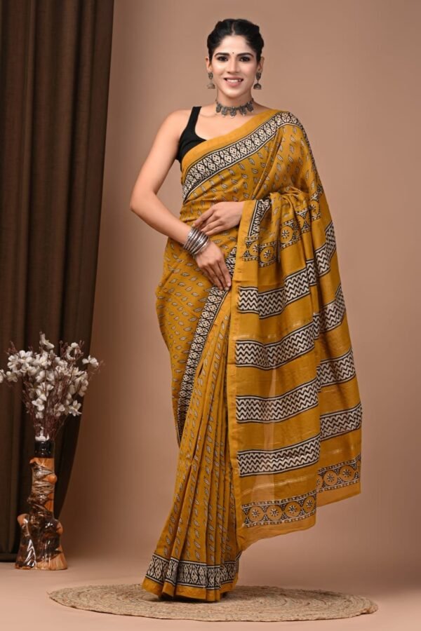 Woman wearing mustard-yellow Chanderi silk saree with Bagru hand block leaf print and zigzag pallu border