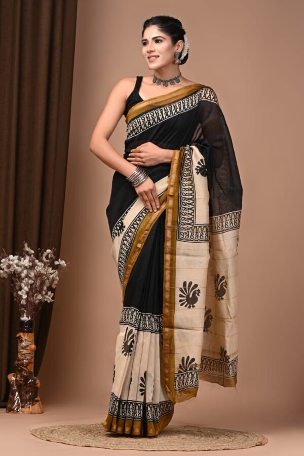 Woman wearing black Chanderi silk saree with cream peacock motif hand block print pallu