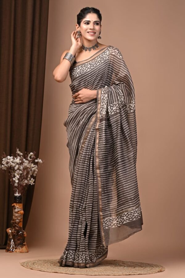 Woman draped in grey and cream striped Chanderi silk saree with hand block printed vine border