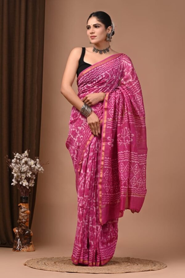 Woman draped in magenta pink Chanderi silk saree with white wavy block print and gold border