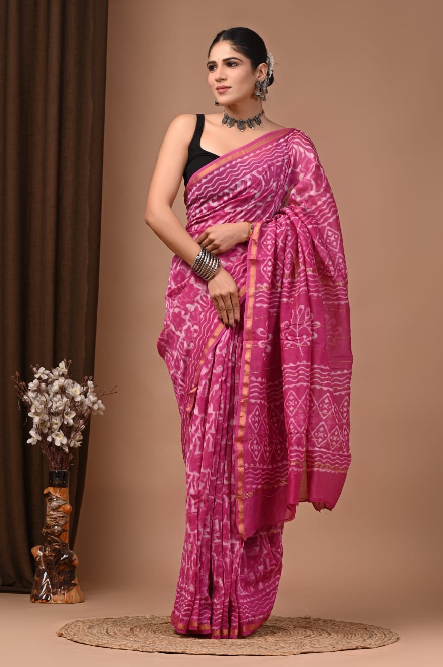 Woman draped in magenta pink Chanderi silk saree with white wavy block print and gold border