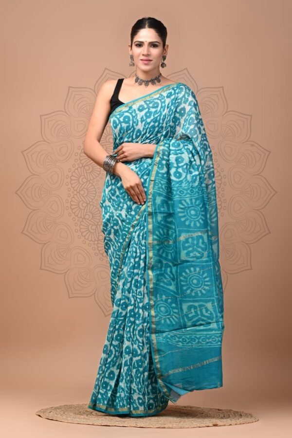 Woman draped in turquoise blue Chanderi silk saree with white floral hand block print and gold border