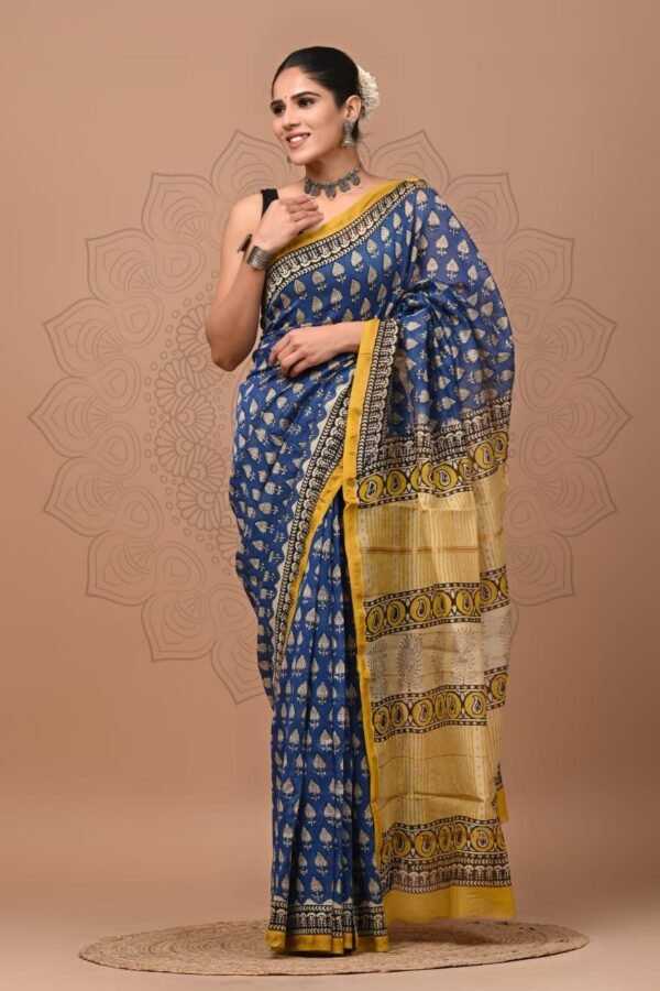 Woman in blue Chanderi silk saree with mustard pallu and Bagru hand block printed leaf motifs