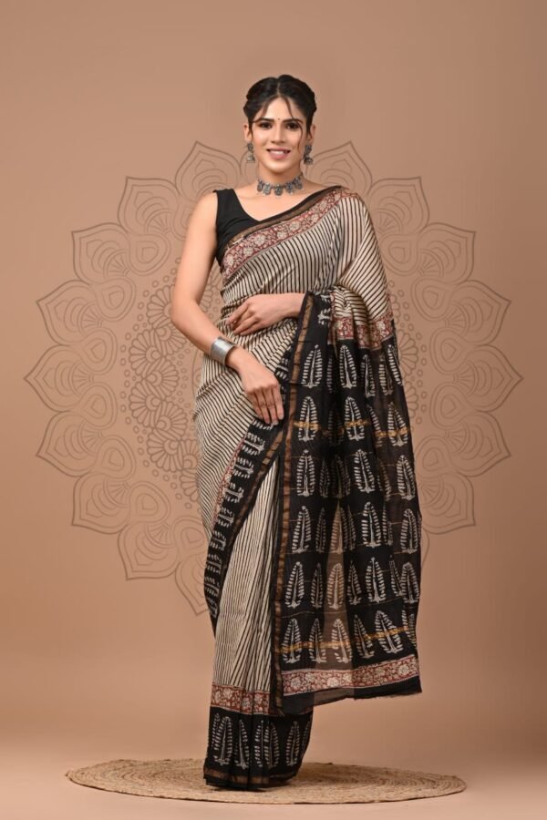 Woman wearing black and cream Chanderi silk saree with Bagru block printed feather motifs and red border