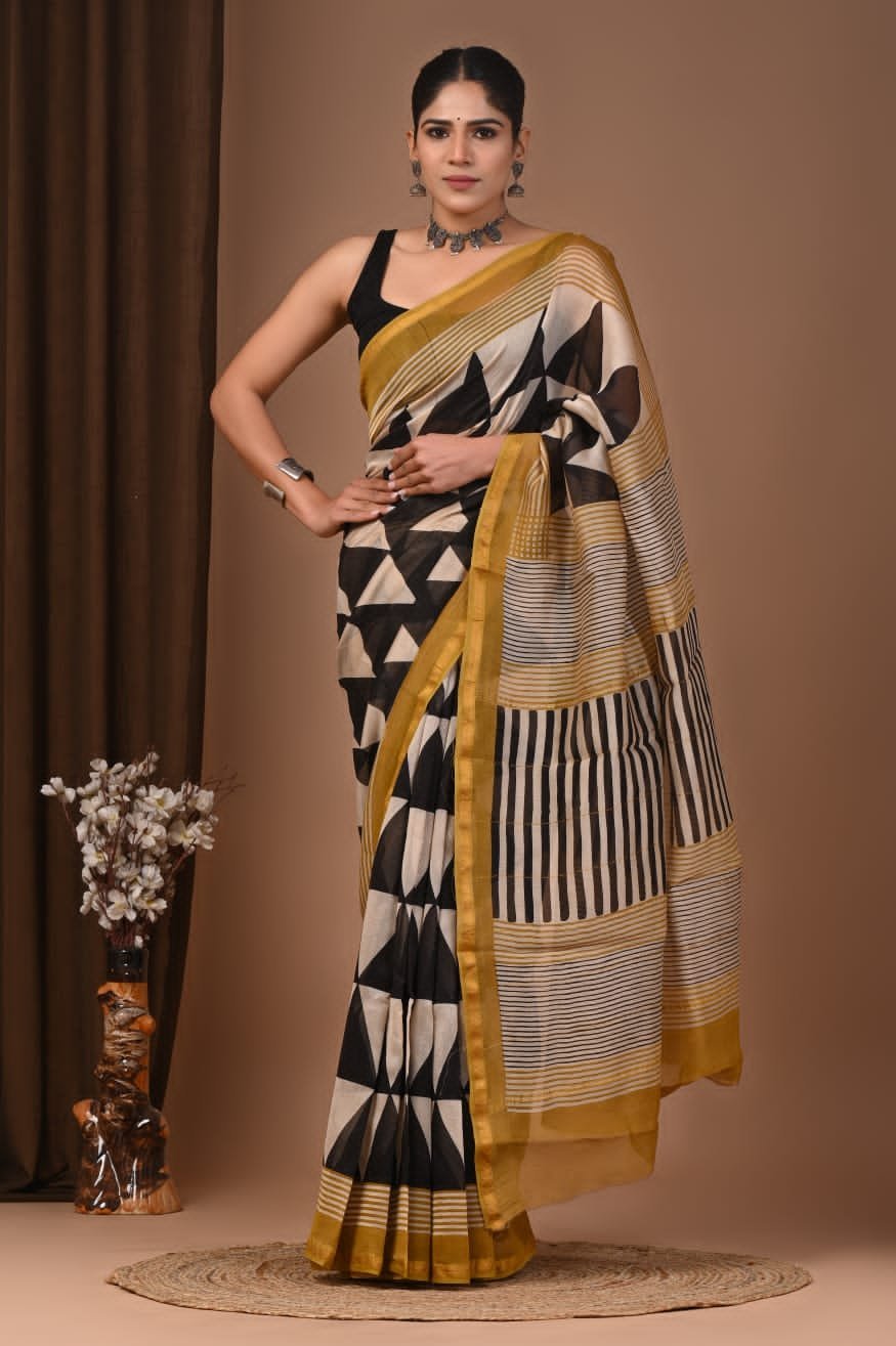 Woman wearing black and cream Chanderi silk saree with geometric triangle block print and mustard border