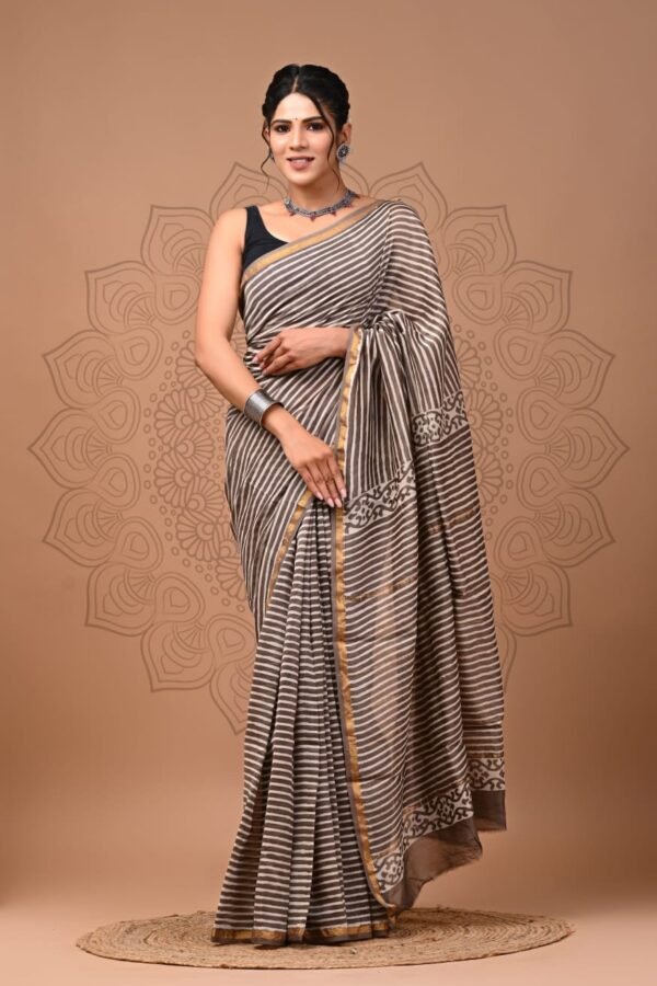 Woman draped in taupe and cream diagonal stripe Chanderi silk saree with floral block print border