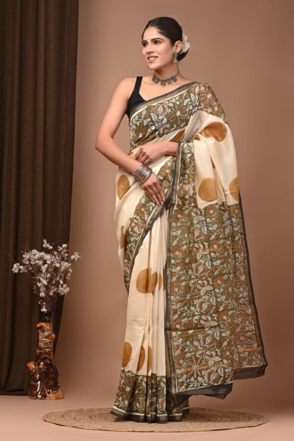 Woman draped in cream Chanderi silk saree with Bagru hand block printed floral border and gold booti motifs