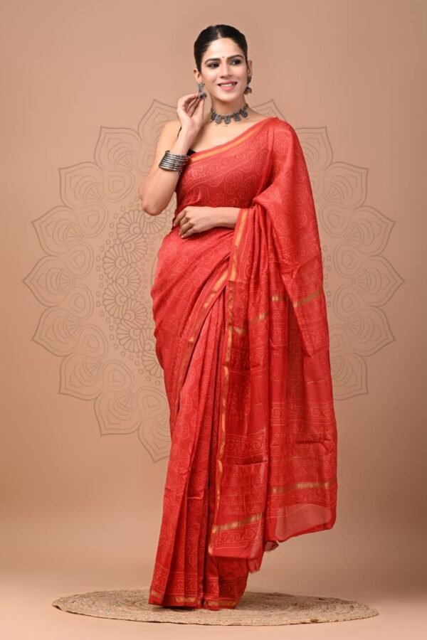 Woman draped in a red hand block printed Chanderi silk saree with golden border, Bagru technique