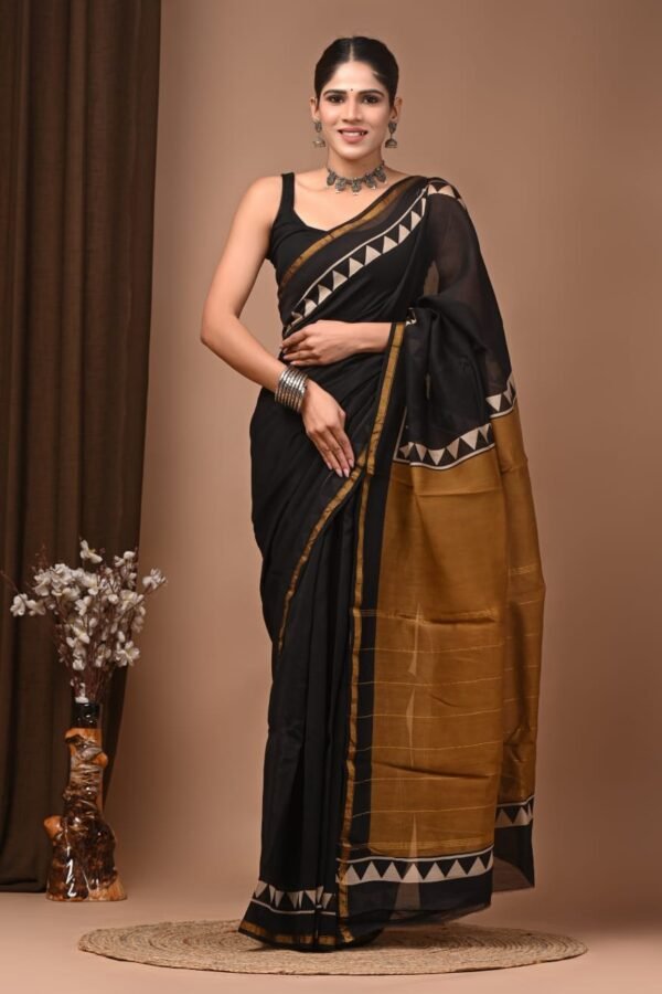 Woman wearing black Chanderi silk saree with mustard pallu and Bagru triangle border print