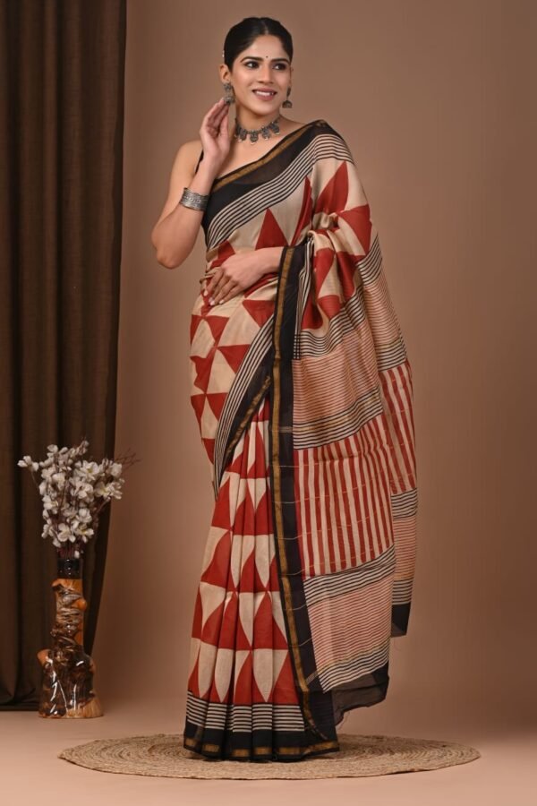 Woman draped in rust-red Chanderi silk saree with geometric triangle print and black striped pallu