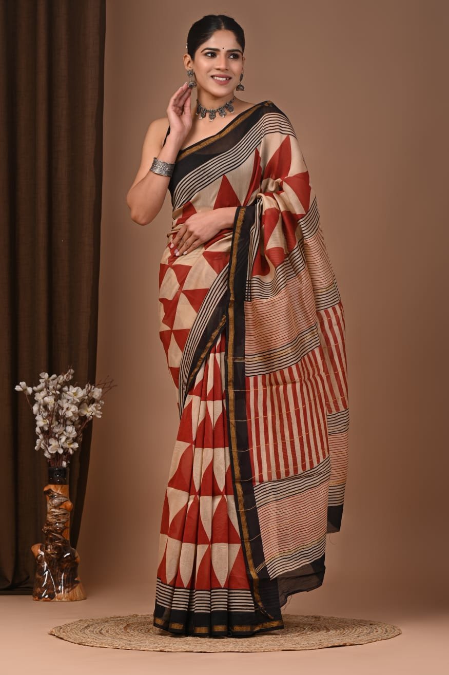 Woman draped in rust-red Chanderi silk saree with geometric triangle print and black striped pallu