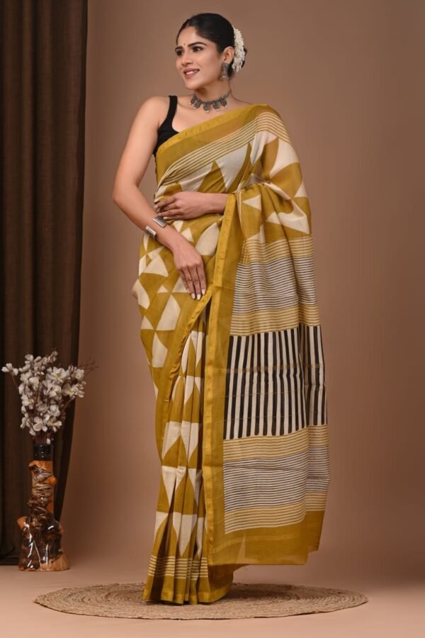Woman draped in mustard-yellow Chanderi silk saree with geometric triangle print and striped pallu