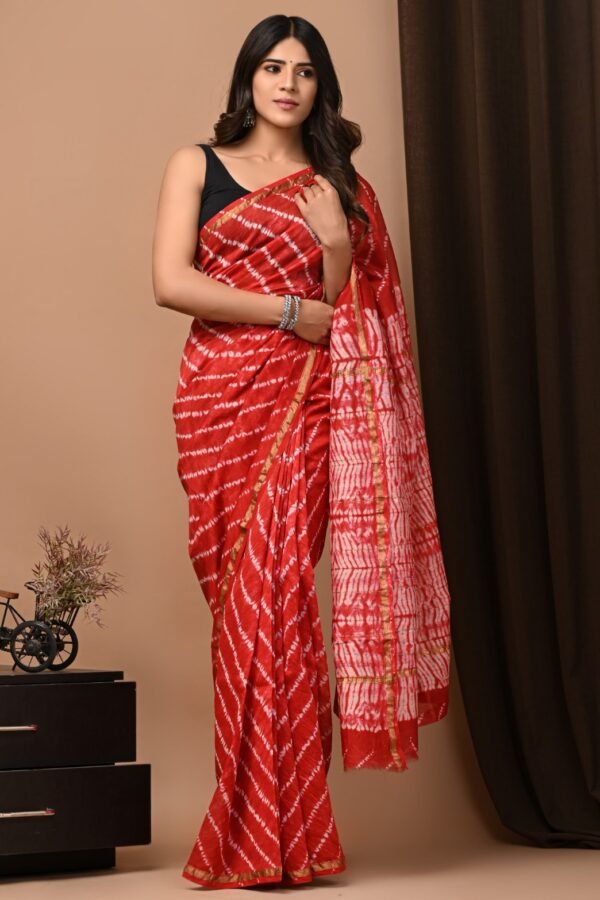 Woman draped in red Chanderi silk saree with white diagonal chevron Bagru hand block print and gold border