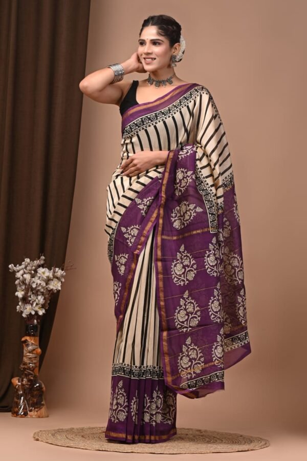 Woman in cream Chanderi silk saree with black stripes and purple floral hand block printed border