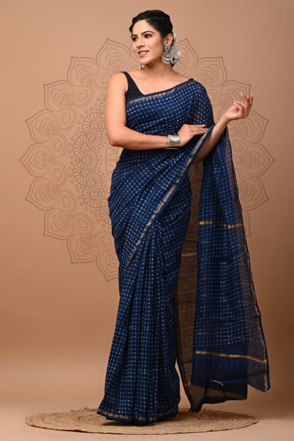 Woman draped in navy blue hand block printed Chanderi silk saree with zari border
