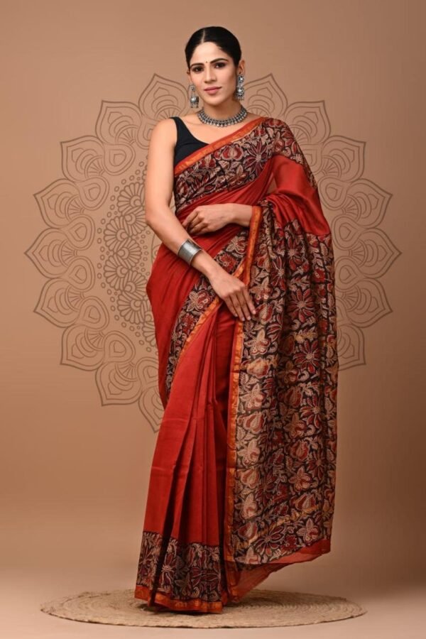Woman wearing rust red Chanderi silk saree with black floral hand block printed border and pallu
