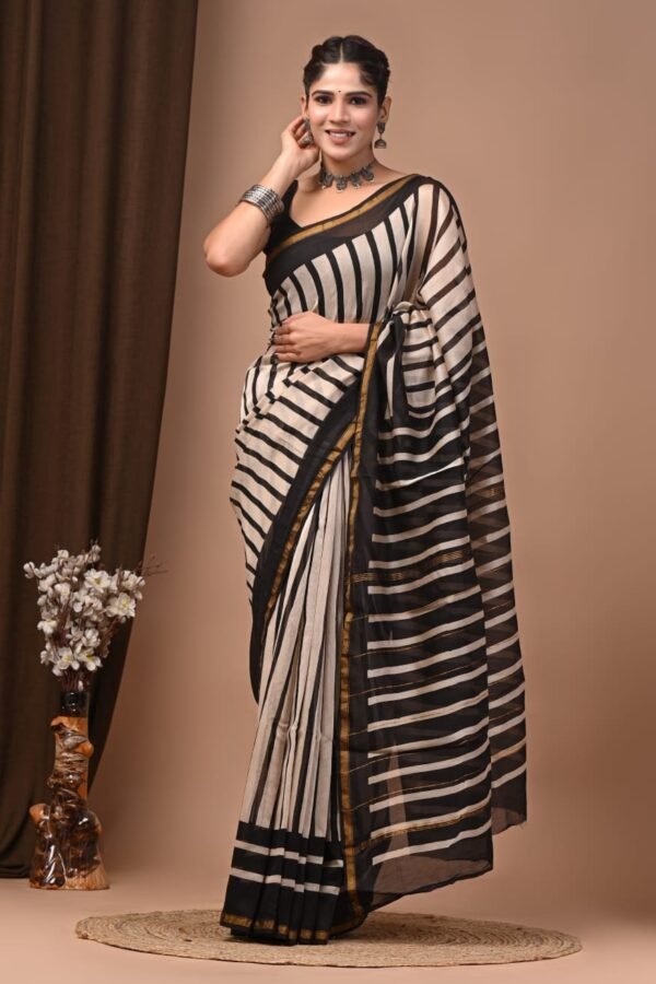 Woman draped in black and cream striped Chanderi silk saree with gold border, Bagru hand block print
