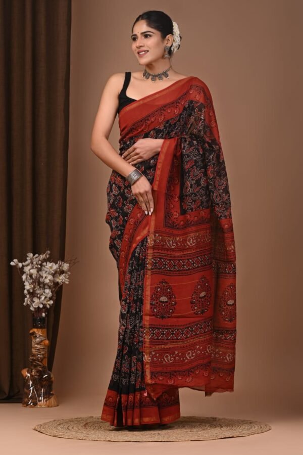 Woman wearing black Chanderi silk saree with rust-red Bagru block printed floral border and pallu