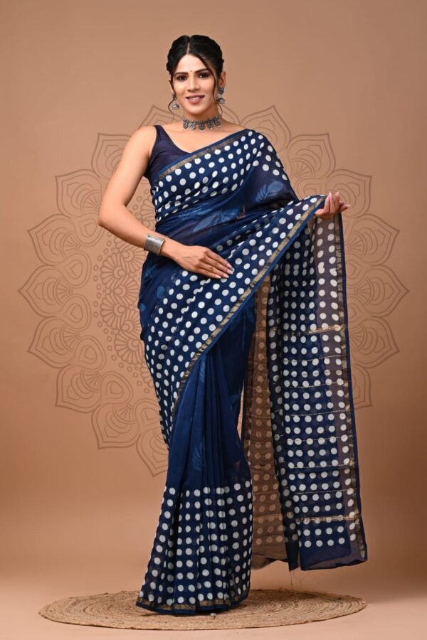 Woman in navy blue Chanderi silk saree with white polka dot print and gold border