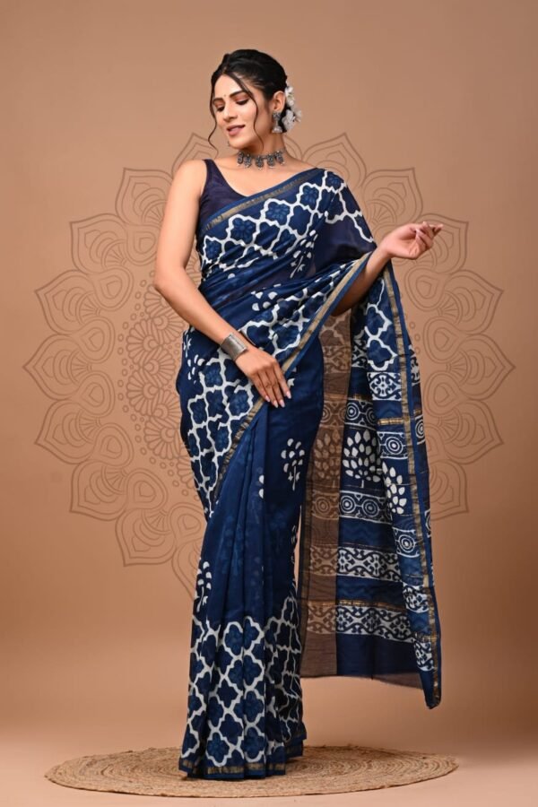 Woman draped in navy blue Chanderi silk saree with white quatrefoil block print and gold border