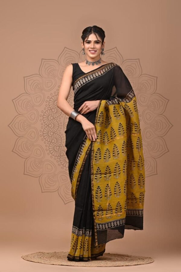 Woman in black Chanderi silk saree with mustard yellow Bagru block printed leaf motif pallu