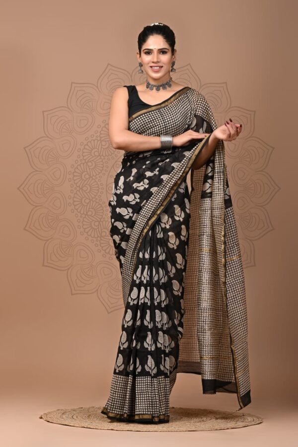 Woman wearing black Chanderi silk saree with white bird motif print and checkered pallu
