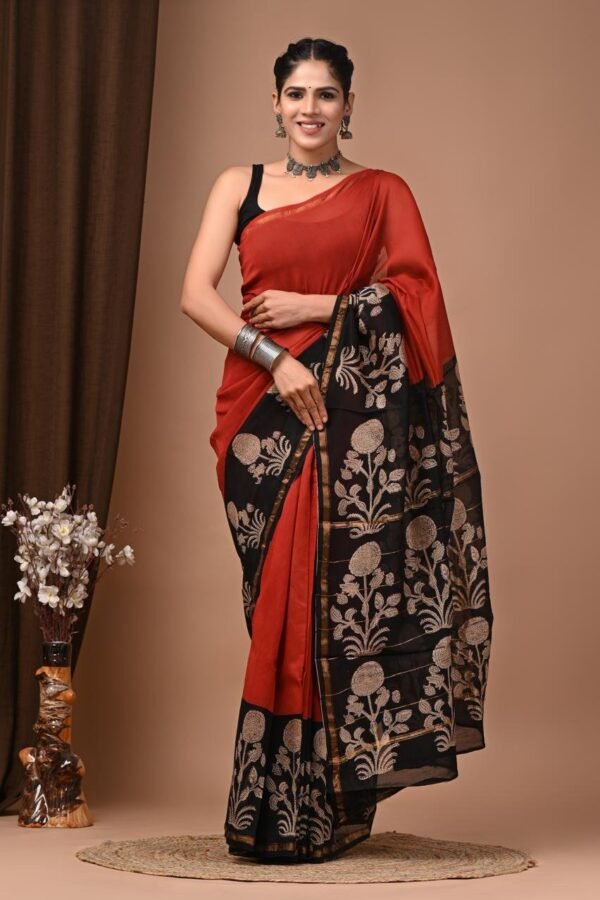 Rust red Chanderi silk saree with black pallu featuring hand block printed golden sunflower motifs