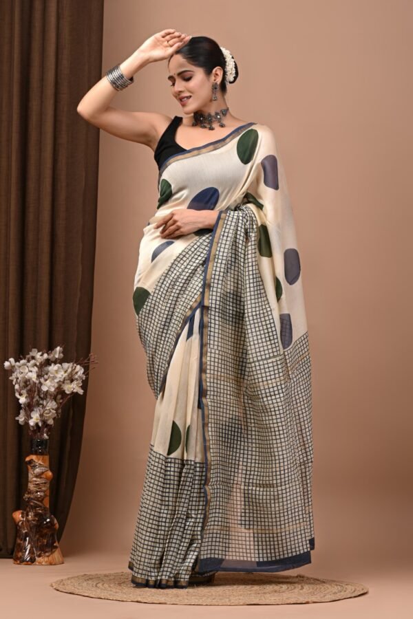 Woman draped in cream Chanderi silk saree with olive-navy polka dots and navy checkered pallu