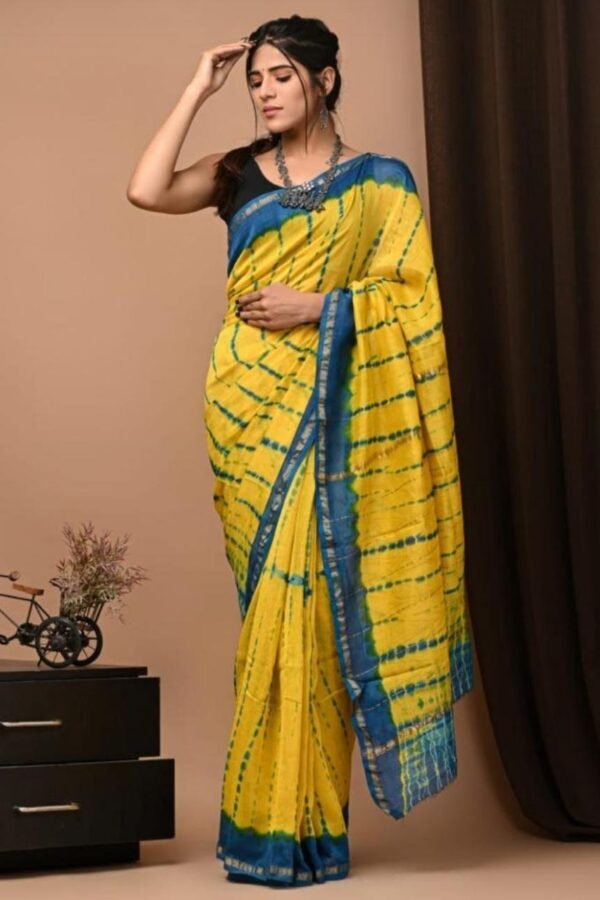 Woman draped in yellow Chanderi silk saree with teal-blue shibori-style streak print and border