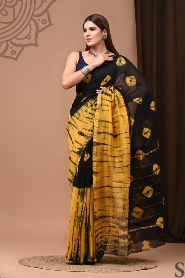 Woman draped in black and mustard-yellow shibori-style hand block print Chanderi silk saree with hexagonal pallu motifs