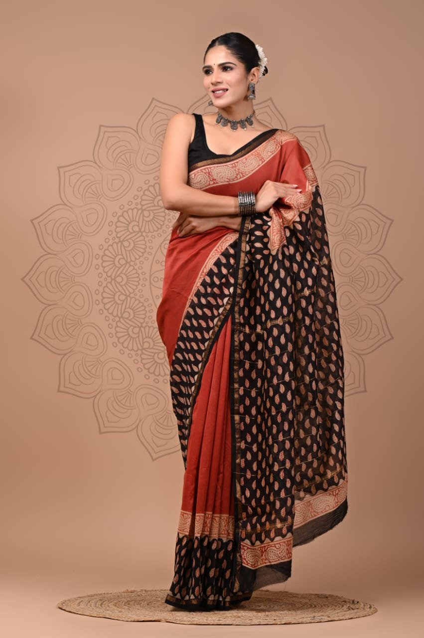 Woman in rust red and black Bagru hand block printed Chanderi silk saree with leaf motif pallu