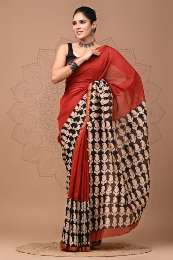 Woman draped in black and cream paisley print Chanderi silk saree with rust red pallu