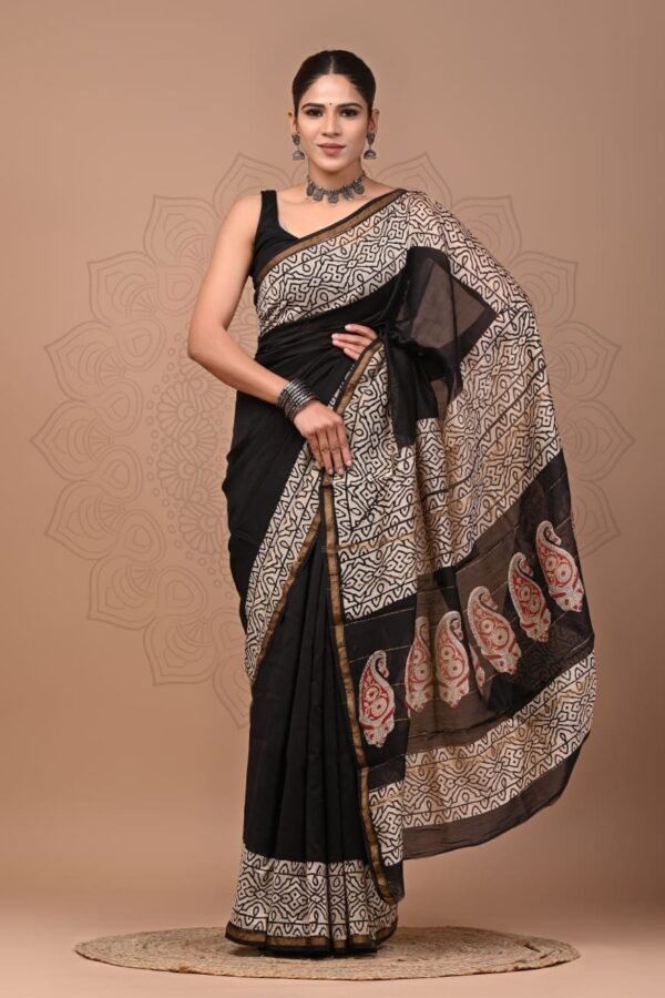 Woman wearing black Chanderi silk saree with cream geometric border and red paisley pallu, Bagru hand block print