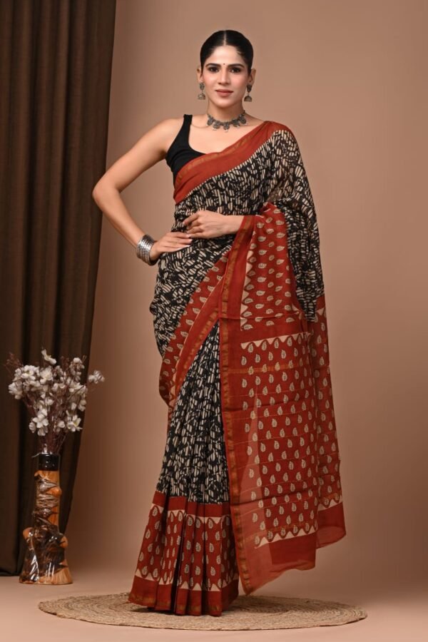 Woman draped in black streak print Chanderi silk saree with rust-red leaf motif pallu, Bagru hand block print