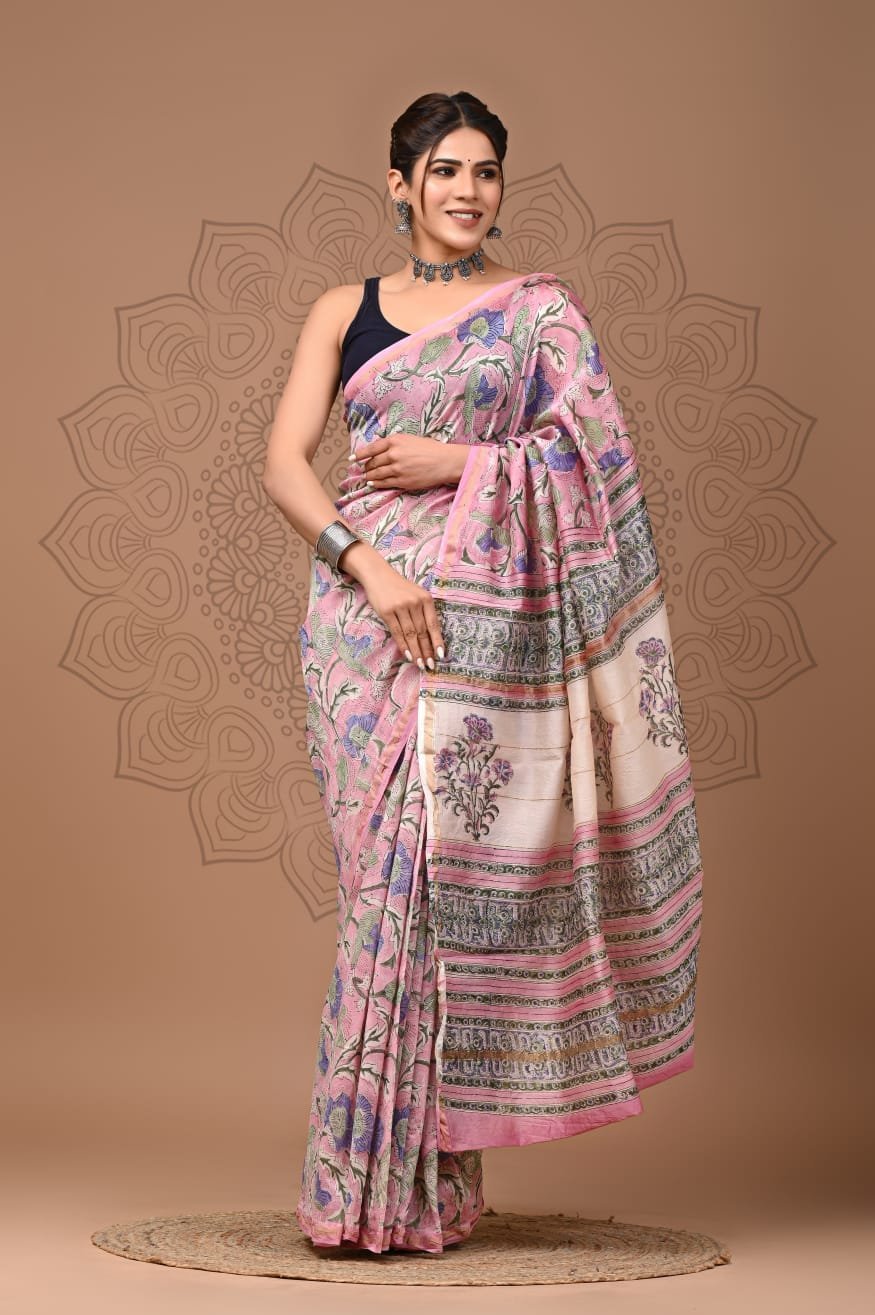 Woman draped in pink floral Chanderi silk saree with cream Bagru hand block printed border