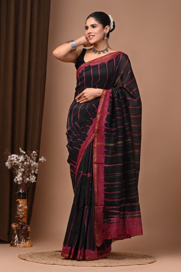 Woman draped in black and magenta shibori-style streak print Chanderi silk saree with block printed border