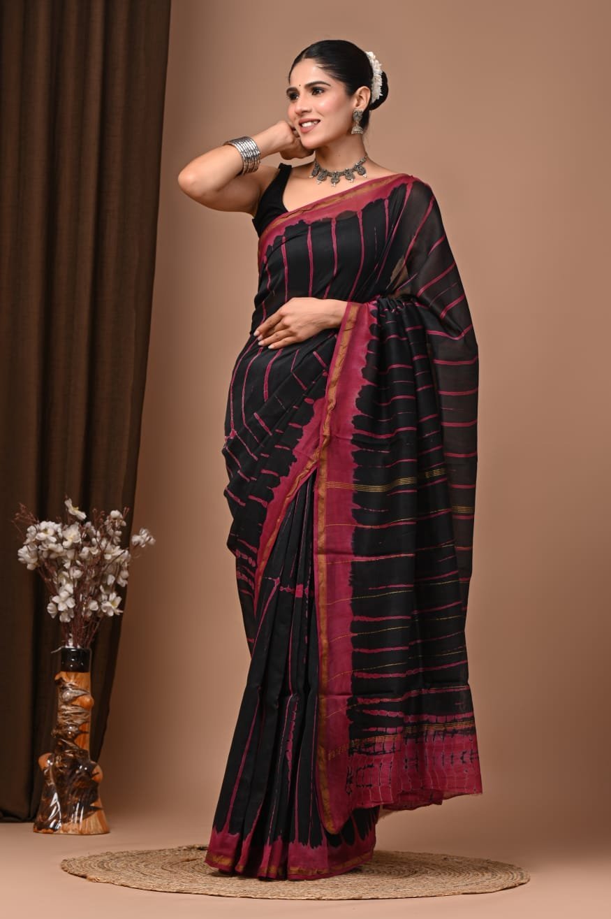 Woman draped in black and magenta shibori-style streak print Chanderi silk saree with block printed border