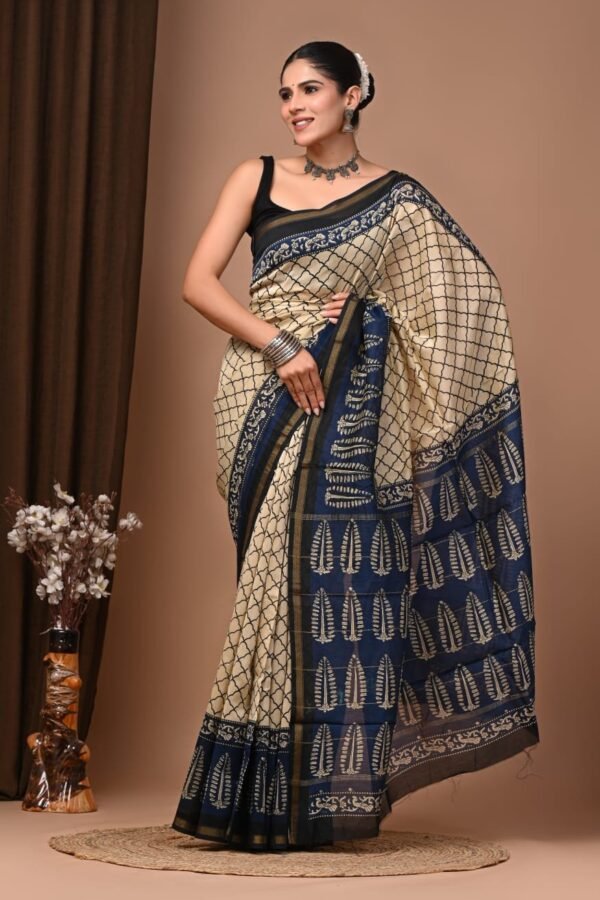 Woman wearing cream and navy blue Chanderi silk saree with Bagru hand block printed lattice and leaf motifs