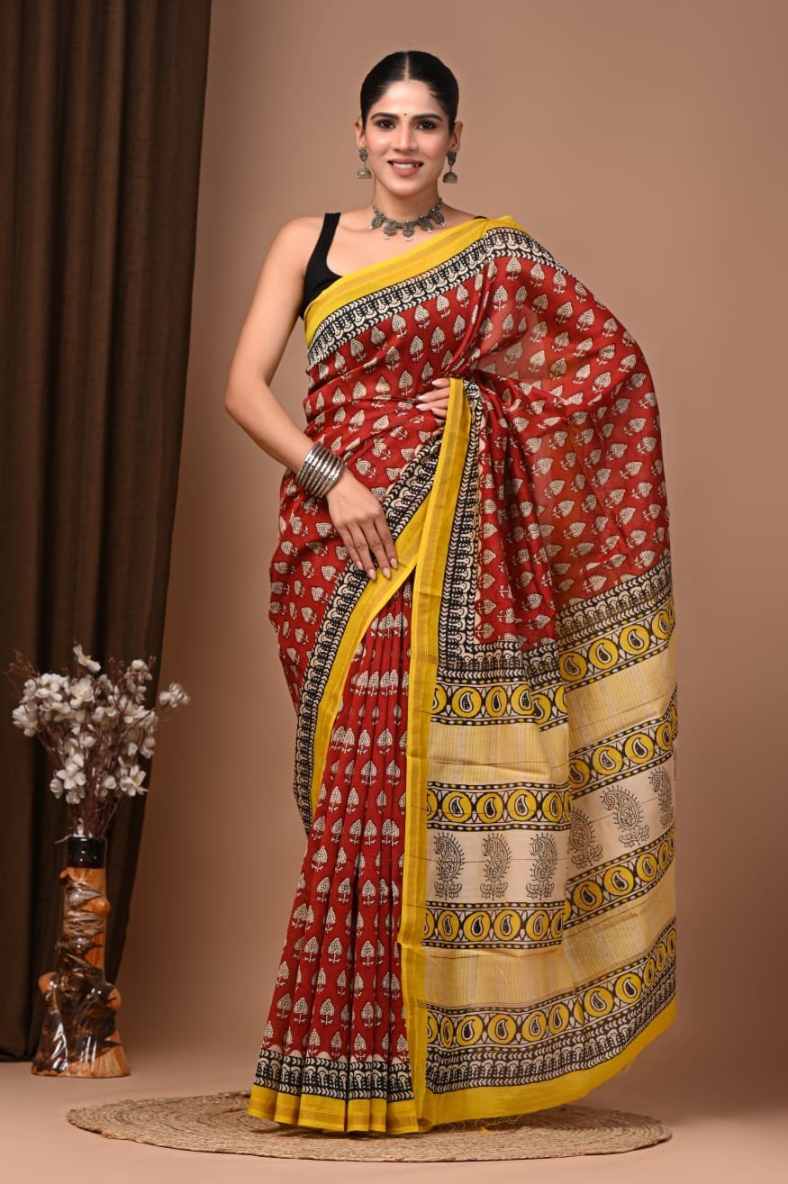 Woman wearing maroon Chanderi silk saree with Bagru hand block print leaf booti and yellow paisley border